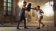 Athletic Woman Hits Punching Bag that Her Partner/ Trainer Holds. She's Professional Fighter and is Training in a Gym.