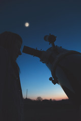 Wall Mural - girl looking at the stars and full moon through a telescope. my astronomy work.