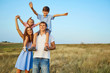 © Studio Romantic - Happy family in nature smiling with their hands up in summer autumn.