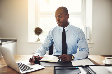 Focused young businessman working at his office desk
