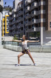 © BGStock72 - Attractive woman exercise stretching in urban environment at sunny day
