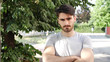 © starsstudio - Handsome young man outdoor looking around and at camera with arms crossed on chest
