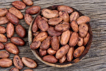 Wall Mural - Cacao beans in a bowl on rustic table