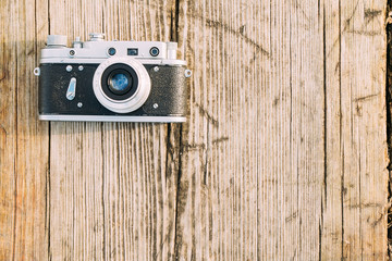 Wall Mural - 35mm Vintage Old Retro Small-Format Rangefinder Camera On Old Wooden