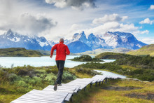 Running Men In Torres Del Paine National Park, Patagonia, Chile