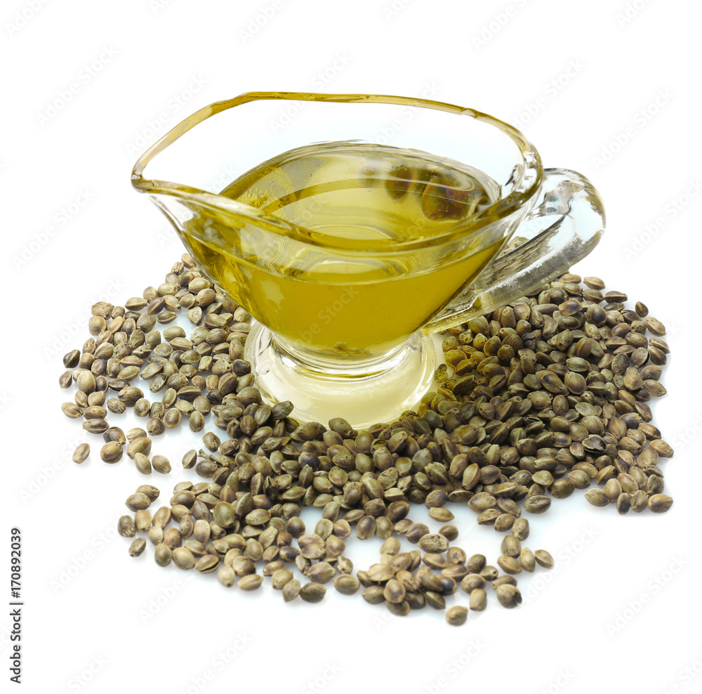 Glass gravy boat with hemp oil isolated on white