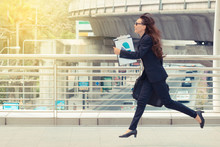 Blurred Motion Of Energetic Business Woman Is Running With Carrying A Briefcase To A Business Meeting. Competition Concept.