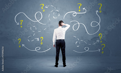 Fotografía Unsure businessman with question marks