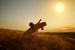 © Studio Romantic - Little girl in pilot's suit in field on nature at sunset.
