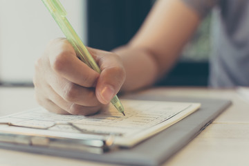 Close up hand asian woman writing on paper