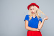 © F8  \ Suport Ukraine - Portrait of a stunning fashionable lady offended girl in bright red dress posing over gray background. Beauty, fashion concept. Colors of summer.