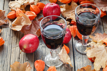 Sticker - red wine in glasses on table in fall leaf