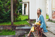 Stylish And Beautiful Young Woman Walks With Dogs