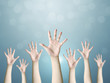 © Monster Ztudio - Group of hand raise up many people, International volunteer day and community service concept
