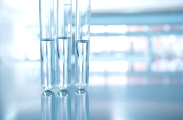 Wall Mural - three glass test tube with water in research science chemical laboratory background