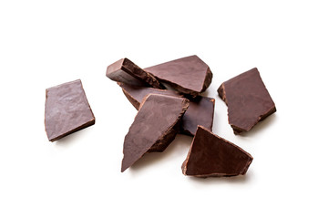 Broken dark chocolate bar isolated on white table. Horizontal composition