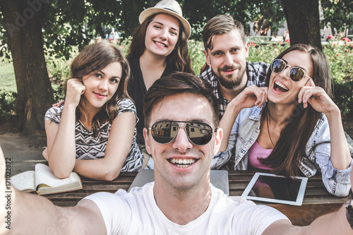 Sunny day.Selfie of young smiling teenagers having fun together. Poster