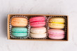 Sweet macarons. Different french cookies macaroons in a paper box.