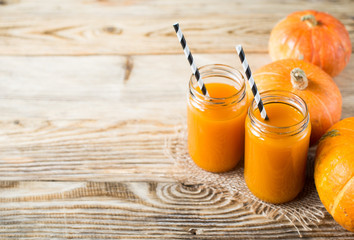 Wall Mural - Pumpkins juice in bottles with pumpkins