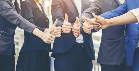 Successful of business teamwork showing thumbs up sign. Business concept.