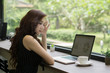 © Johnstocker - Young business woman working on laptop at office.