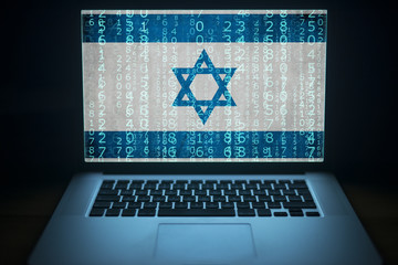 Israeli hacker. Laptop with binary computer code and an Israel flag on the screen. Internet and network security.