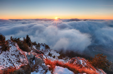 Wall Mural - above clouds in winter - mountain landcape at sunset, slovakia