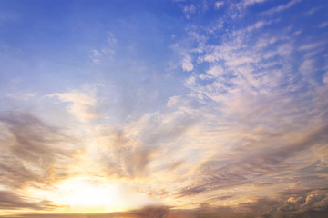 Wall Mural - sunset / sun rise sky with rays of yellow and red light shining clouds and sky background and textur