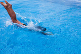 Fototapeta Łazienka - Girl jumping on swimming pool with Black sea view, splashing of water