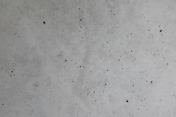 Grey concrete inner wall with scratches and holes