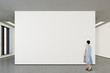 © dimamoroz - Woman looking at blank poster in modern gallery