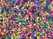 Close Up On Many Colorful Candy Pieces. Bright Colorful Florescent Colors. Flat Lay Top View Background