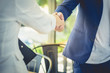 © Fluky - Male and female businessmen are handshake agree to join the business.On a white background .Focus at hand