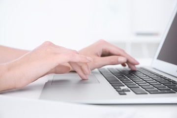 Sticker - Young woman using laptop for searching information in internet at table