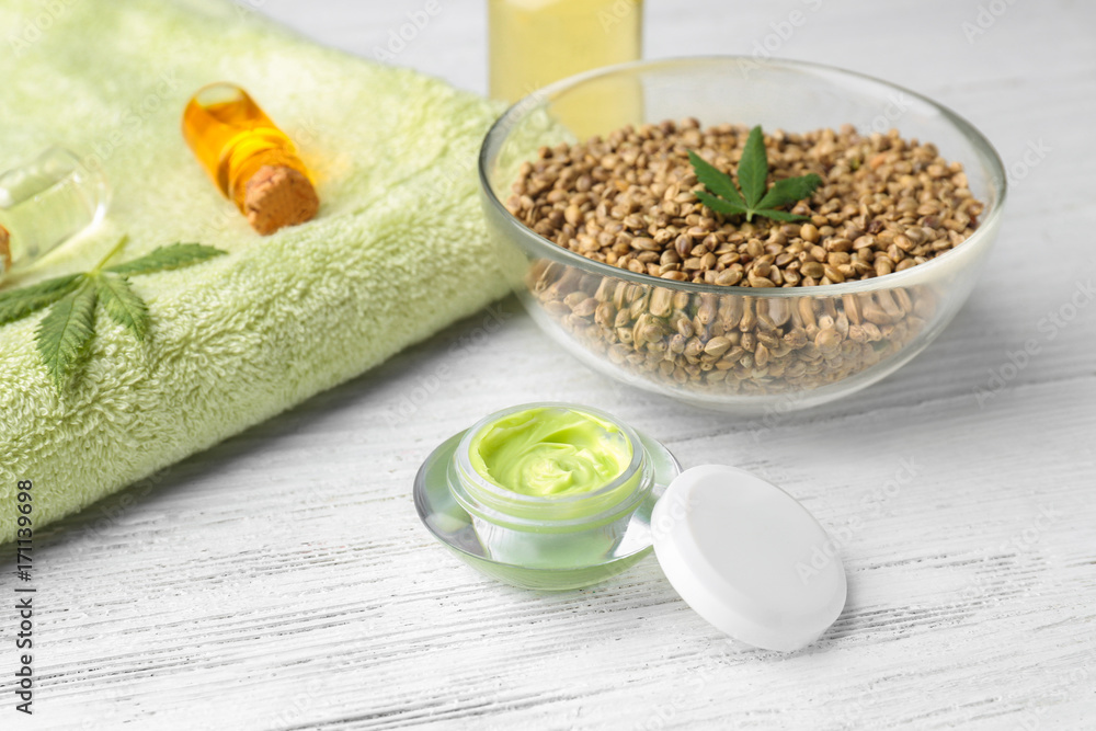 Composition with hemp lotion on white wooden background