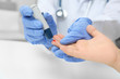 © Africa Studio - Doctor in latex gloves taking sample of patient's blood using lancet pen. Diabetes concept
