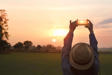 Tourist Woman Taking Photo With Smartphone On Sunset Nature Background
