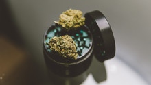 Buds Of Marijuana In The Grinder Close-up.  .Varietal Marijuana And Smoking Culture 420