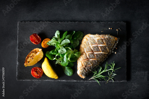 Fotografie, Obraz Baked dorado with fresh salad and vegetables. Top view