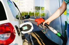 Car Refueling On Petrol Station. Woman Pumping Gasoline Oil