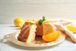 © Africa Studio - Tray with delicious sliced cake and citrus fruits on wooden table