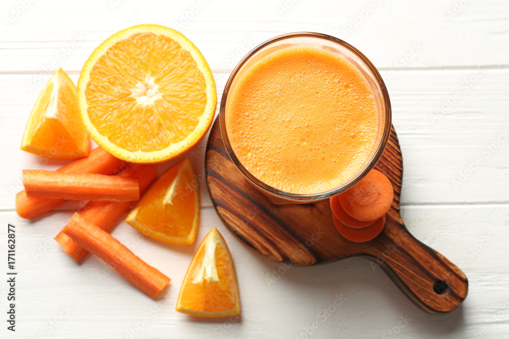 Glass with fresh juice  and ingredients on wooden table