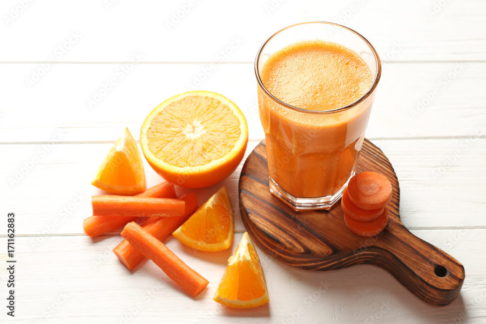 Glass with fresh juice  and ingredients on wooden table