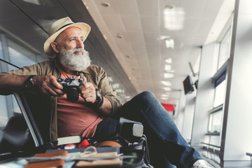 Thoughtful smiling man expecting for flight