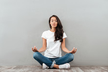 Beautiful Young Asian Woman Sitting In Yoga Position And Meditating