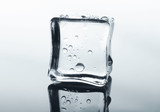 Fototapeta Łazienka - Transparent ice cube on glass with water drops