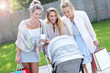 © Kalim - Trendy modern mother with friends outside with a stroller