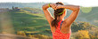 sportswoman against scenery of Tuscany looking into distance