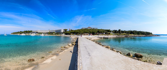  Seaside hotel with beach and turquoise water, Sveti Andrija or Red island near Rovinj, Croatia