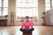© Wavebreak Media - Woman doing yoga on hardwood floor